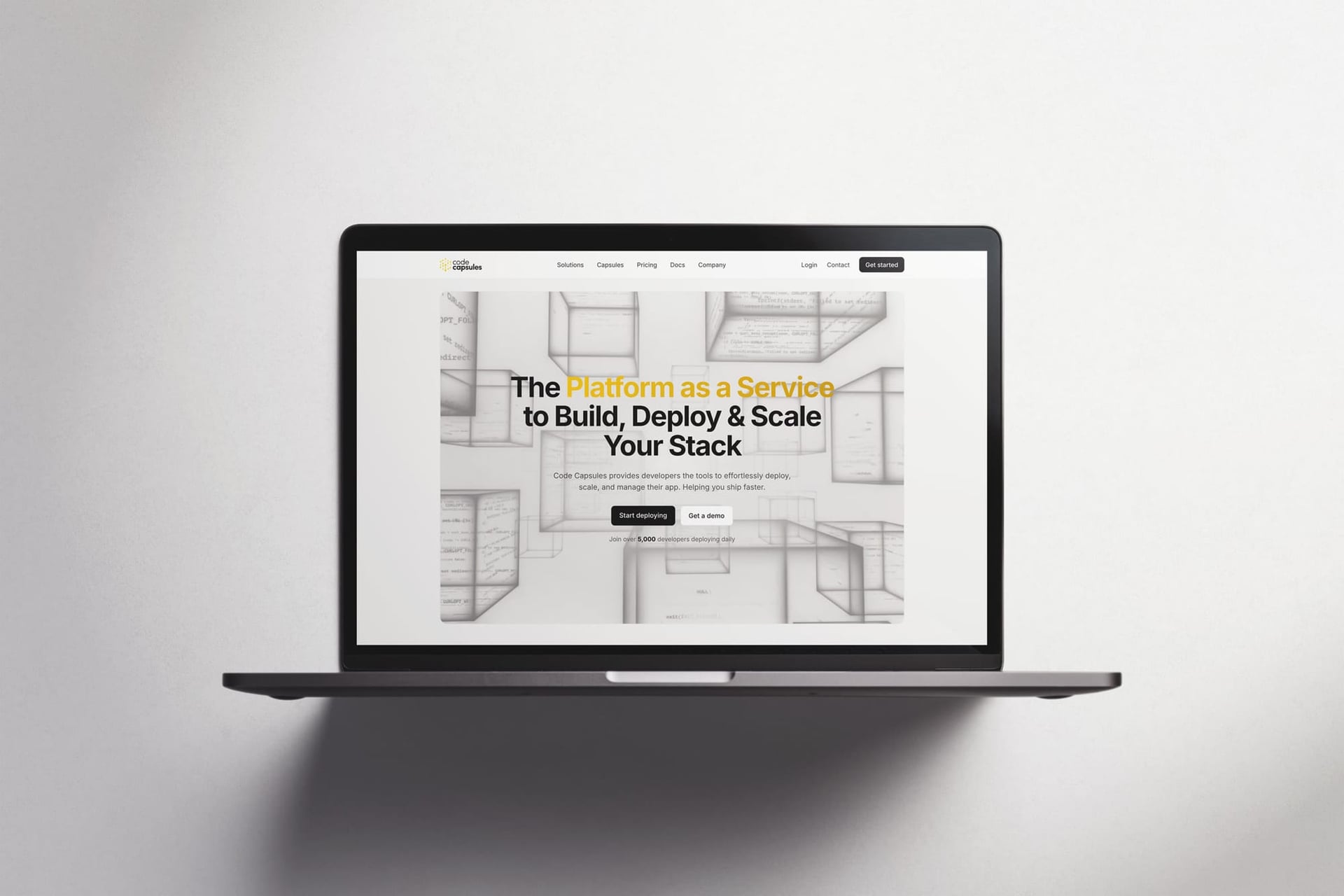 The codecapsules.io homepage on a laptop